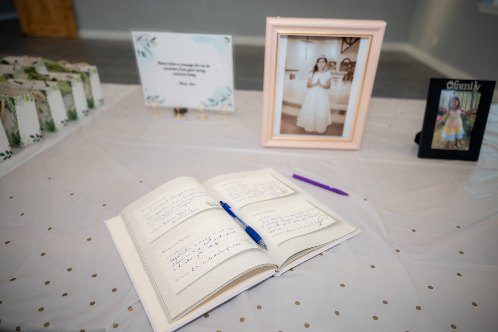 First Communion celebration table setup with guest message book, framed photos, and party favors, captured by Zan Visuals as part of professional event photography.