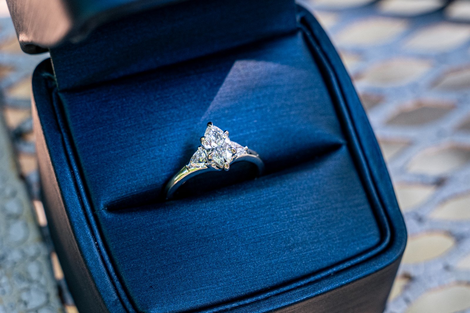 Close‑up detail shot of a diamond ring in a blue box — taken by Zan Visuals.
