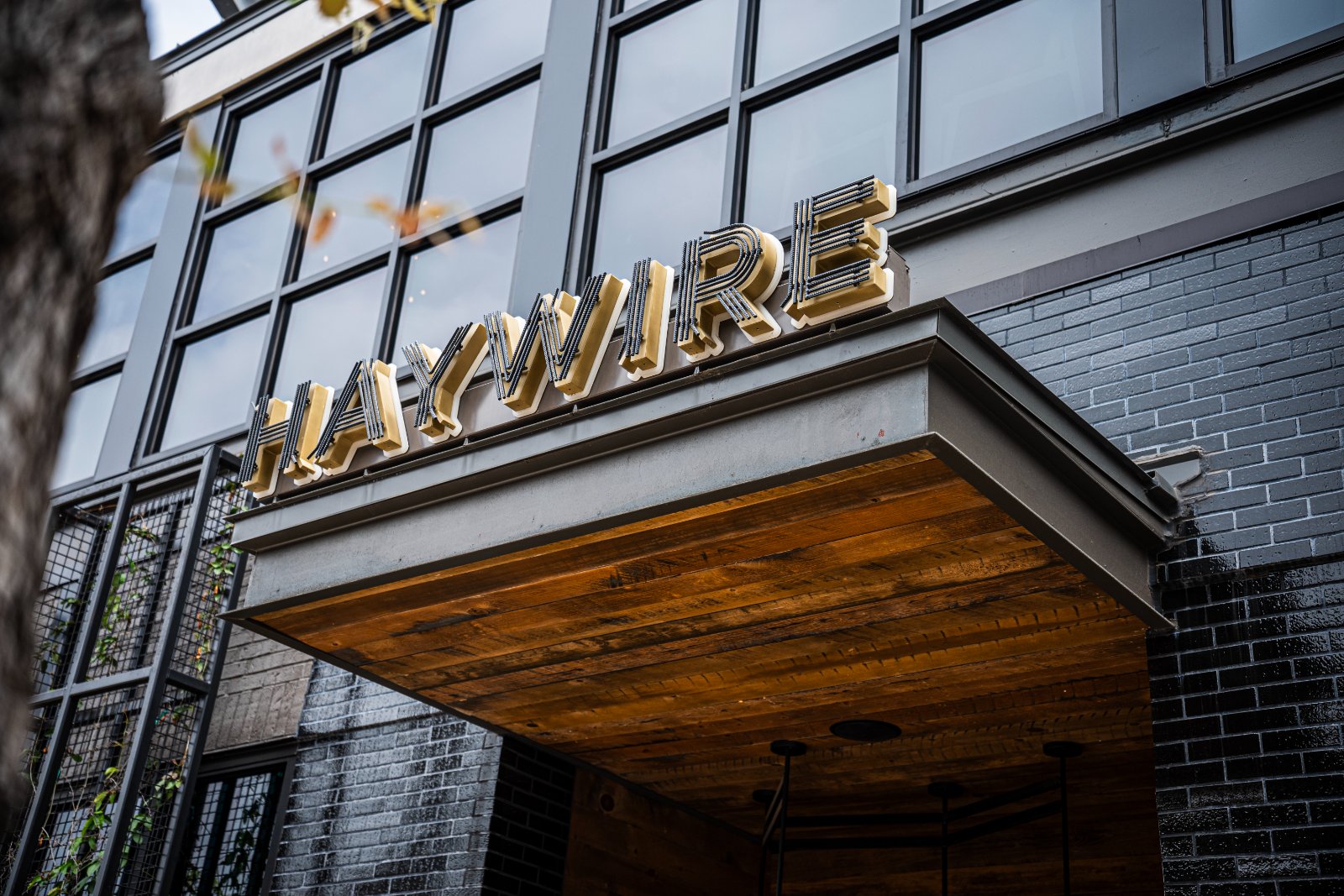 Exterior photo of Haywire restaurant entrance with bold signage, captured for Brohan Real Estate event — photographed by Zan Visuals.